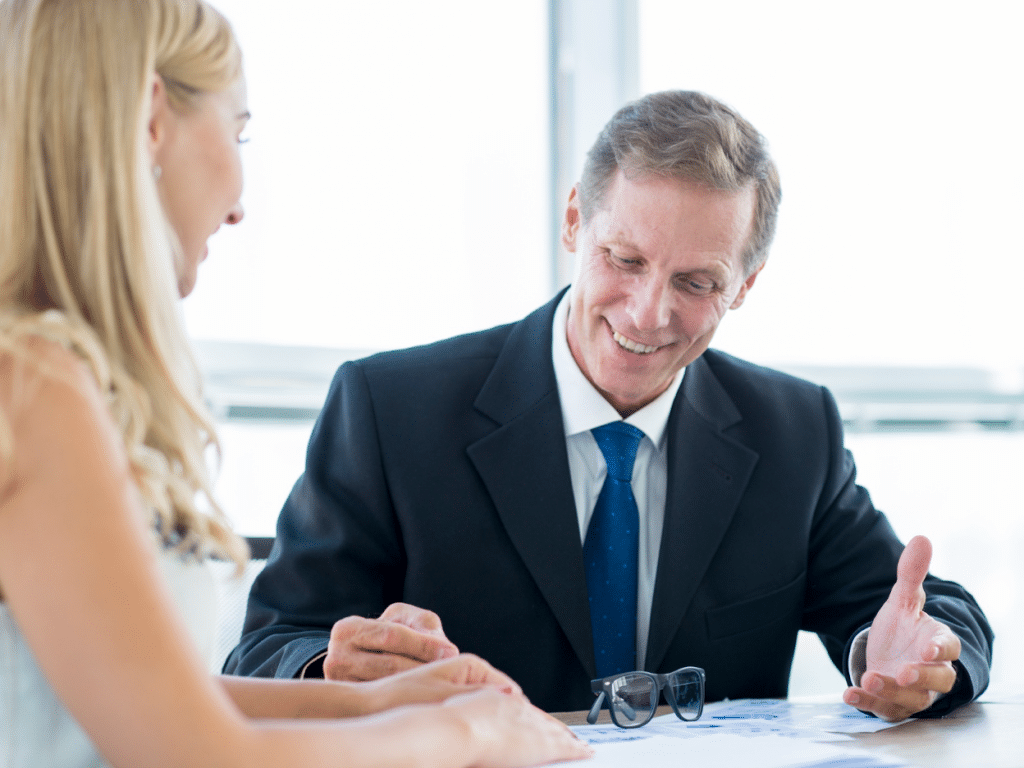 Attorney in a suit discussing case details with a client.