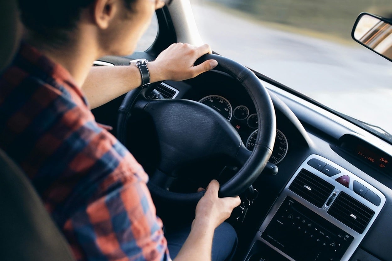Driver gripping the steering wheel of a car before a traffic stop in Texas