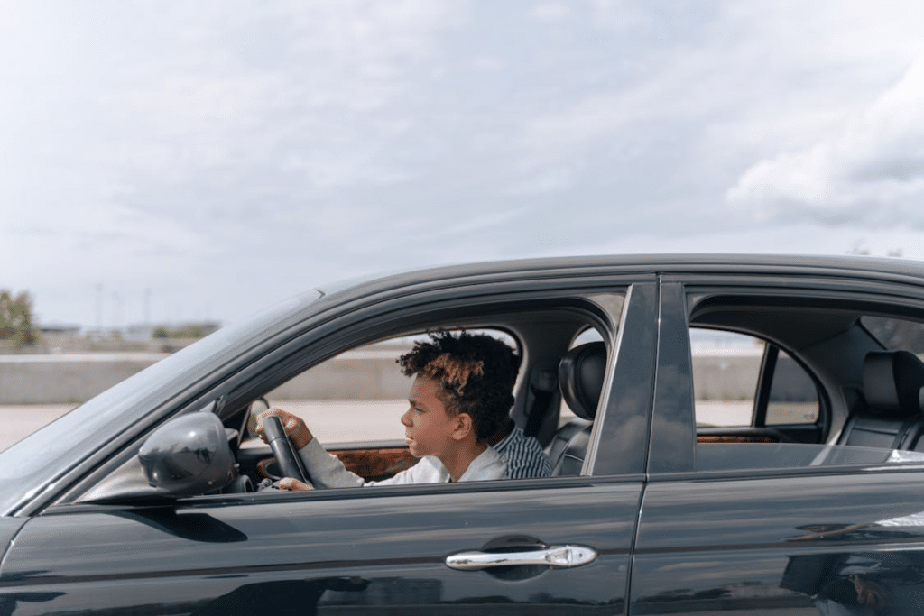 Young driver behind the wheel of a car on a Texas highway
