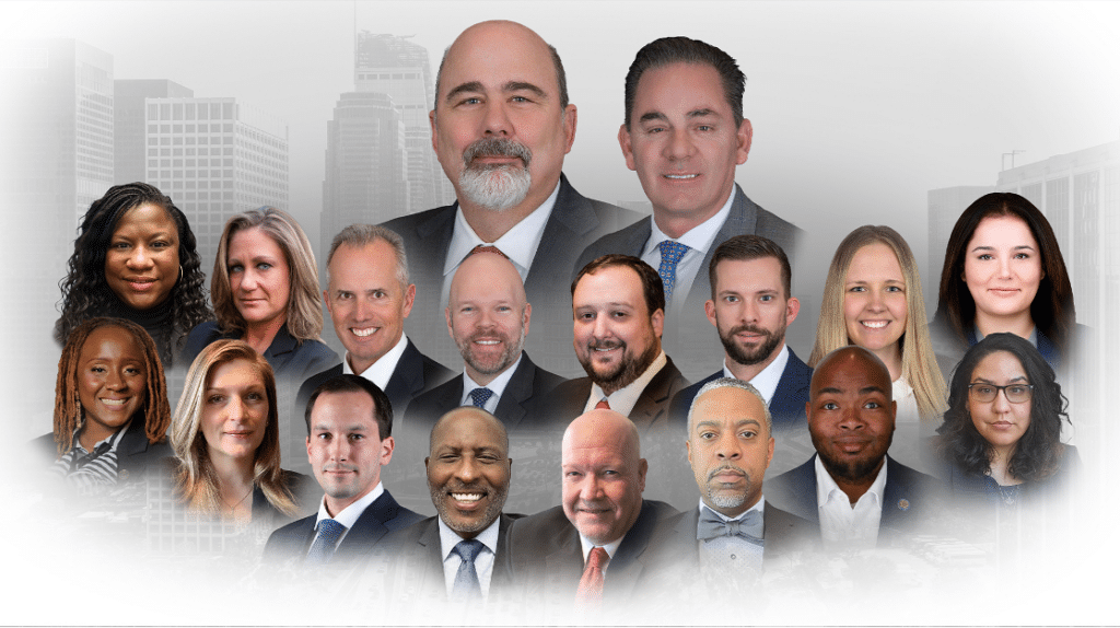 A professional composite portrait of a legal team against a city skyline background.